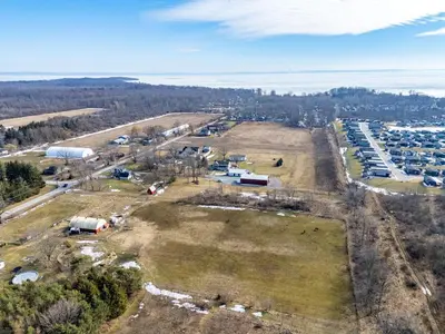 an aerial view of a farm with a lot of cars at Vintage 8BR Farmhouse With Hot Tub Spacious Yard in Port Colborne