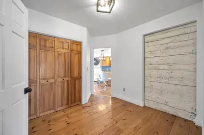 an empty room with a wooden door in a house at Vintage 8BR Farmhouse With Hot Tub Spacious Yard in Port Colborne