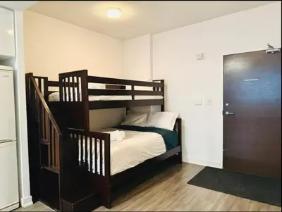 a bedroom with a bunk bed and a staircase at KingBed & Bunkbed & Terrace in Toronto