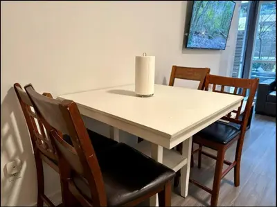 a candle sitting on top of a table with chairs at KingBed & Bunkbed & Terrace in Toronto