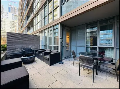 a patio with chairs and a table in a building at KingBed & Bunkbed & Terrace in Toronto