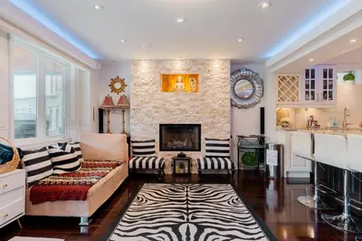 a living room with a couch and a fireplace at Richmond Hill Ravine Retreat in Richmond Hill