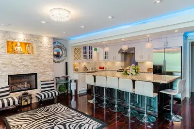 a kitchen with a large island with bar stools at Richmond Hill Ravine Retreat in Richmond Hill