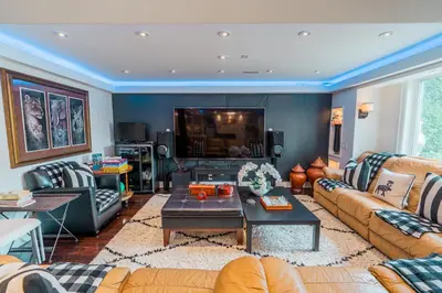 a living room with couches and a tv at Richmond Hill Ravine Retreat in Richmond Hill