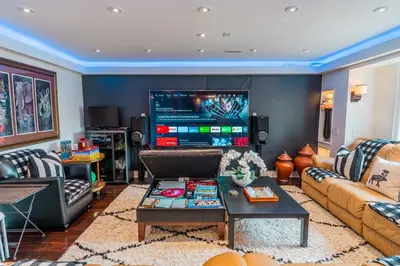 a living room with a couch and a tv at Richmond Hill Ravine Retreat in Richmond Hill