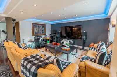 a living room with couches and a tv at Richmond Hill Ravine Retreat in Richmond Hill