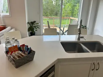 a kitchen counter with a sink and a basket of snacks at The Angus Nest in Angus