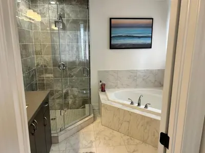 a bathroom with a shower and a tub and a sink at The Angus Nest in Angus