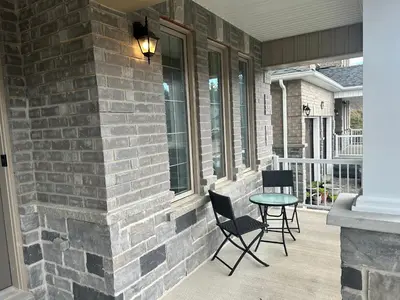 a patio with two chairs and a table on a house at The Angus Nest in Angus