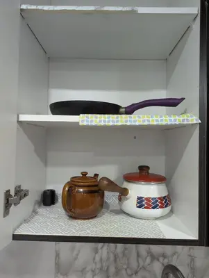 a shelf with a pot and a tea kettle on it at Basement two Queen beds and one single with two full washrooms by YKF airport in Kitchener