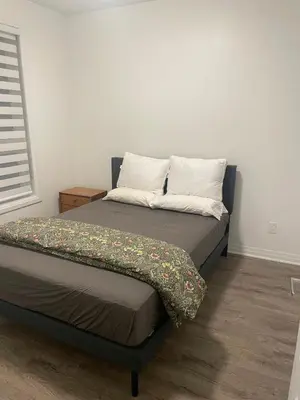 a bed with two pillows and a blanket on it at Executive Luxury Apartment in Oakville