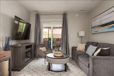 a living room with a couch and a table at Casa Hotel Elegant Suite w Patio BBQ Grill in Toronto