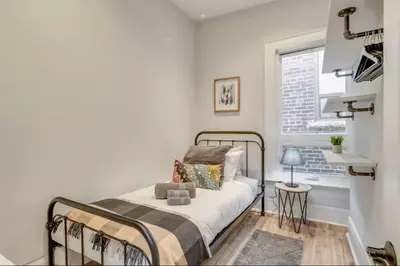 a bedroom with a bed and a window at Casa Leslieville - 2BR Suite with LRG Patio in Toronto