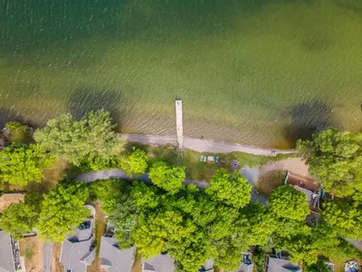 an overhead view of a park with trees and water at Le Papillon - 77 Butternut in Cherry Valley