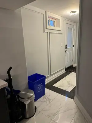 a room with a hallway with a door and a trash can at Oshawa Connect - Prime Location, Modern Space in Oshawa