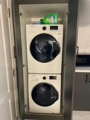 two washing machines in a room with a door at Oshawa Connect - Prime Location, Modern Space in Oshawa