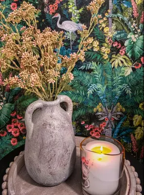 a candle and a vase sitting on a table at The Studio Southampton in Southampton