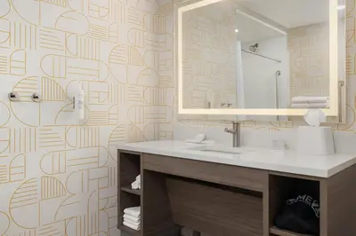 a bathroom with a sink and a mirror at Home2 Suites By Hilton Vaughan Toronto On in Vaughan