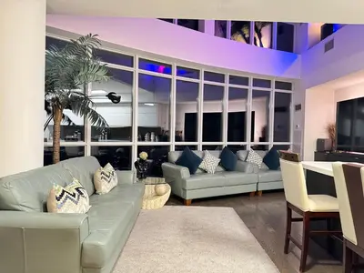 a living room with a couch and a table at Two Storey Penthouse with 2 Parkings and Lake & City Views in Toronto