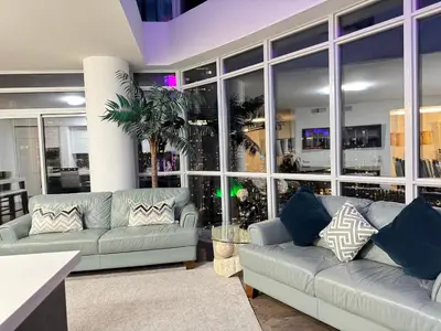 a living room with two couches and a table at Two Storey Penthouse with 2 Parkings and Lake & City Views in Toronto