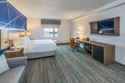 a hotel room with a bed and a desk at Comfort Inn & Suites in Bradford
