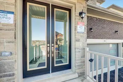 a home with a glass door with a balcony at West Oak, Detached New Modern House In South Barrie - Built H plus ME Technology in Barrie