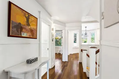 a white hallway with a painting on the wall at Stylish & Spacious 3BR in Downtown Toronto in Toronto
