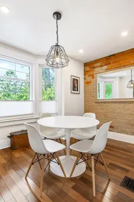 a dining room with a white table and chairs at Stylish & Spacious 3BR in Downtown Toronto in Toronto