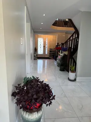 a hallway with a vase with flowers in it at Private Single Bedroom in City Centre Q66 in Mississauga