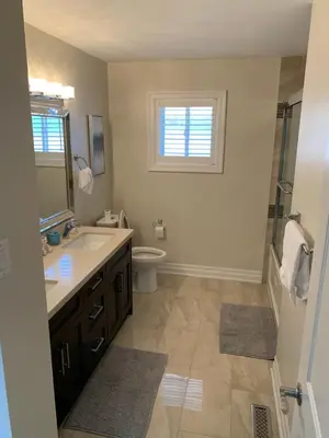 a bathroom with a sink and a toilet and a window at Private Single Bedroom in City Centre Q66 in Mississauga