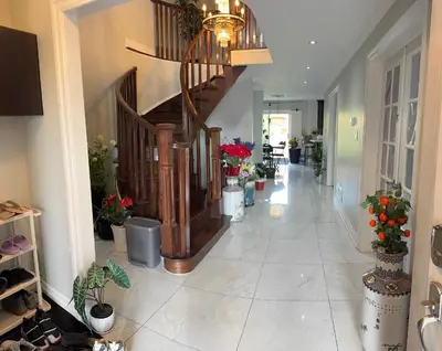 a hallway with a staircase with potted plants at Bright Private Single Bedroom Q33 in Mississauga