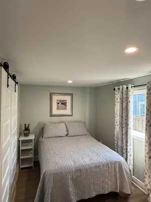 a bedroom with a bed and a window at ORS Beach Corporation Wasaga Beach Cottage in Wasaga Beach
