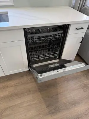 an oven with its door open in a kitchen at ORS Beach Corporation Wasaga Beach Cottage in Wasaga Beach