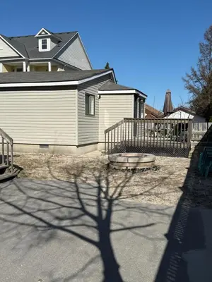 a shadow of a tree in front of a house at ORS Beach Corporation Wasaga Beach Cottage in Wasaga Beach