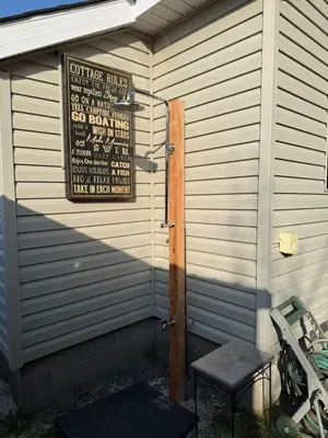 a building with a sign on the side of it at ORS Beach Corporation Wasaga Beach Cottage in Wasaga Beach