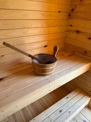 a wooden bowl with a spoon in a sauna at ORS Beach Corporation Wasaga Beach Cottage in Wasaga Beach