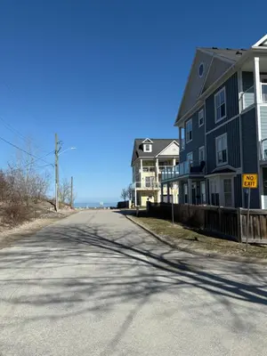 an empty street with houses on the side of the road at ORS Beach Corporation Wasaga Beach Cottage in Wasaga Beach
