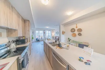 a large kitchen with a large counter top and wooden cabinets at Entire home in Oakville, Canada in Oakville