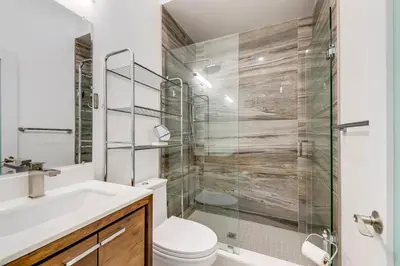 a bathroom with a shower and a toilet and a sink at Toronto Midtown Home Suites in Toronto