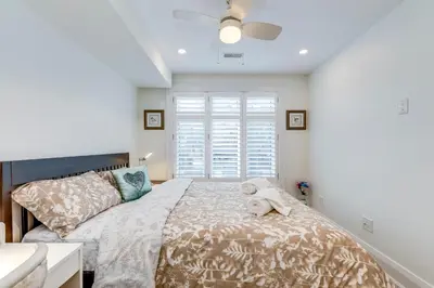 a bedroom with a bed with a dog laying on it at Toronto Midtown Home Suites in Toronto