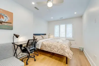 a bedroom with a bed and a desk and a chair at Toronto Midtown Home Suites in Toronto