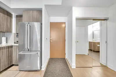 a kitchen with a stainless steel refrigerator in it at Modern Condo with Balcony, Gym and Free Parking in Toronto