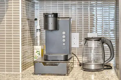 a kitchen counter with a coffee maker and a blender at Modern Condo with Balcony, Gym and Free Parking in Toronto