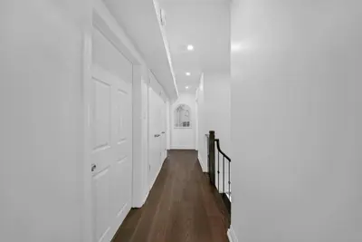 a hallway with white walls and a white door at Hidden 3BR Gem with Workspace, Fast wifi and Parking in Toronto