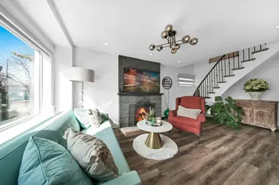 a living room with a couch and a fireplace at Hidden 3BR Gem with Workspace, Fast wifi and Parking in Toronto