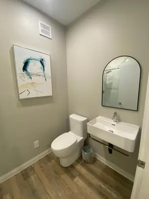 a bathroom with a white toilet and a sink at ENTIRE BACHELOR UNIT EN-SUITE ACROSS FROM GOOGLE - br2 in Kitchener