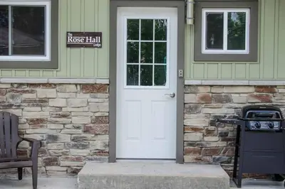 a house with a white door and a stove at The Rosehall PEC Waterfront Stay in Wellington