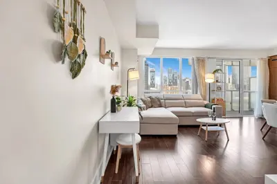 a living room with a couch and a table at Boho 2bdrm Sleeps 6 near Rogers MTCC Union CN tower in Toronto