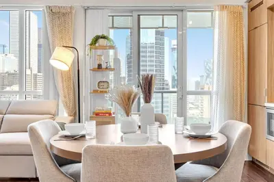 a living room with a table and chairs and a couch at Boho 2bdrm Sleeps 6 near Rogers MTCC Union CN tower in Toronto