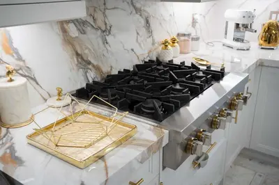a kitchen with a stove top with a gold tray on it at 6 Bedroom Luxury House with a Bright Sunroom in Mississauga